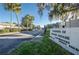 Community entrance sign with palm trees, and lush landscaping at 4242 Sheldon Pl, New Port Richey, FL 34652
