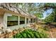Exterior view of the property with lush foliage, showing the patio and ample green space for outdoor enjoyment at 4242 Sheldon Pl, New Port Richey, FL 34652