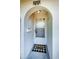 Close-up view of the front entrance featuring a welcome mat and a secure screen door at 4242 Sheldon Pl, New Port Richey, FL 34652