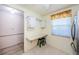 Eat-in kitchen featuring a built-in desk, white cabinets, and floral window treatments at 4242 Sheldon Pl, New Port Richey, FL 34652
