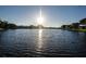 Expansive view of the peaceful lake reflecting the sunlight, showcasing the serene environment at 4242 Sheldon Pl, New Port Richey, FL 34652