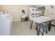 Laundry room with multiple machines, folding tables, and sinks for residents' convenience at 4242 Sheldon Pl, New Port Richey, FL 34652