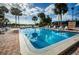 Bright, well-maintained outdoor swimming pool with palm trees and plenty of lounge chairs at 4242 Sheldon Pl, New Port Richey, FL 34652