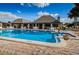 Bright, well-maintained outdoor swimming pool with tables and umbrellas for relaxation at 4242 Sheldon Pl, New Port Richey, FL 34652
