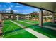 Outdoor shuffleboard courts with covered seating areas for residents' recreational use at 4242 Sheldon Pl, New Port Richey, FL 34652