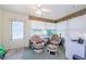 Bright sunroom with large windows, comfortable seating, and a ceiling fan for relaxed living and enjoying natural light at 4242 Sheldon Pl, New Port Richey, FL 34652