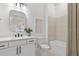 Bright bathroom featuring modern vanity, framed mirror, and combined shower with tile surround at 4951 Ribbon Rock Cv, Lakewood Ranch, FL 34211