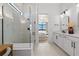 Bright bathroom featuring a glass shower, double vanity, and modern fixtures at 4951 Ribbon Rock Cv, Lakewood Ranch, FL 34211