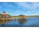 Picturesque waterfront view with a wooden dock and gazebo on a clear day at 4951 Ribbon Rock Cv, Lakewood Ranch, FL 34211