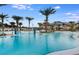 Large community pool with fountains, palm trees and lounge chairs in a new home community at 4951 Ribbon Rock Cv, Lakewood Ranch, FL 34211