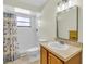 Bathroom featuring a shower with white tile surround, and vanity with large mirror at 5133 Abagail Dr, Spring Hill, FL 34608