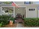 Inviting porch with seating and decor, enhancing the home's curb appeal and charm at 5401 S Russell St, Tampa, FL 33611