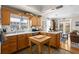 Spacious kitchen with natural wood cabinets, white countertops, and an adjacent dining area at 5401 S Russell St, Tampa, FL 33611