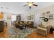 Comfortable living room with hardwood floors, a ceiling fan, and views into the kitchen at 5401 S Russell St, Tampa, FL 33611
