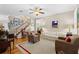 Inviting living room with hardwood floors, neutral tones, staircase and plantation shutters at 5401 S Russell St, Tampa, FL 33611