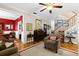 Cozy living room showcasing hardwood floors, a piano, and an open view to the dining area at 5401 S Russell St, Tampa, FL 33611