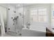 Bright main bathroom featuring a soaking tub, a walk-in shower, and large windows at 5401 S Russell St, Tampa, FL 33611