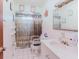 Compact bathroom featuring tiled walls, standard fixtures, and functional accessibility features at 549 E Center St, Tarpon Springs, FL 34689