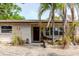Charming single-story home with brick facade, garden accents and mature landscaping at 549 E Center St, Tarpon Springs, FL 34689