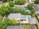 This aerial view showcases a property with a pool, spa, screened patio, and a large backyard with privacy at 6007 N Suwanee Ave, Tampa, FL 33604