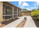 This property features a screened lanai and detached garage with paver and concrete walkway and manicured landscaping at 6007 N Suwanee Ave, Tampa, FL 33604