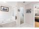 Bathroom with soaking tub, a glass enclosed shower and neutral paint at 6007 N Suwanee Ave, Tampa, FL 33604