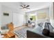A bright bedroom with a ceiling fan, closet, and daybed at 6007 N Suwanee Ave, Tampa, FL 33604