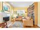 Bright living room with hardwood floors, a fireplace, and built-in bookshelves at 6007 N Suwanee Ave, Tampa, FL 33604