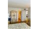 Bedroom with decorative armoire and side table leading to the attached bathroom at 6020 Shore S Blvd # 903, Gulfport, FL 33707