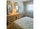 Comfortable bedroom featuring ornate dressers, matching mirrors, and light filtering curtains at 6020 Shore S Blvd # 903, Gulfport, FL 33707