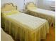 Cozy bedroom featuring two twin beds with bright yellow bedspreads and matching linens at 6020 Shore S Blvd # 903, Gulfport, FL 33707