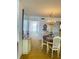 Dining area with chandelier and adjacent buffet, leading to additional hallway, bright and airy at 6020 Shore S Blvd # 903, Gulfport, FL 33707