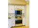 Kitchen area with stove, microwave, and linoleum flooring at 6020 Shore S Blvd # 903, Gulfport, FL 33707