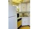 Kitchen area with tile backsplash, linoleum flooring, and yellow countertops at 6020 Shore S Blvd # 903, Gulfport, FL 33707