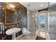 Unique bathroom with custom wall coverings, glass shower, and access to patio at 6130 Kipps Colony W Dr, Gulfport, FL 33707