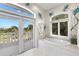 Bright bathroom boasts garden tub, peacock accents, and a door to the private balcony at 6130 Kipps Colony W Dr, Gulfport, FL 33707