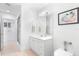 Bright bathroom features a single sink vanity, framed mirror, tiled floors, and glass enclosed shower at 6130 Kipps Colony W Dr, Gulfport, FL 33707