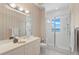 Bathroom with shower, sleek vanity and scenic water view from window at 6130 Kipps Colony W Dr, Gulfport, FL 33707