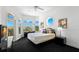 Comfortable bedroom with large windows offering natural light and neighborhood views at 6130 Kipps Colony W Dr, Gulfport, FL 33707