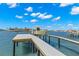 Private boat dock with boat lift, providing convenient access to the open bay and Gulf of Mexico at 6130 Kipps Colony W Dr, Gulfport, FL 33707