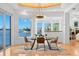 Dining room offering stunning water views and a modern chandelier at 6130 Kipps Colony W Dr, Gulfport, FL 33707
