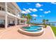 Luxury waterfront home featuring a private pool, outdoor seating, and panoramic water views at 6130 Kipps Colony W Dr, Gulfport, FL 33707