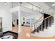 Grand foyer with circular staircase and views into the living area and waterfront at 6130 Kipps Colony W Dr, Gulfport, FL 33707