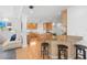 Spacious kitchen features wooden cabinetry, a breakfast bar with stools, and hardwood floors at 6130 Kipps Colony W Dr, Gulfport, FL 33707
