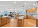 Open kitchen layout with island, wood cabinetry, and views of the waterfront and living area at 6130 Kipps Colony W Dr, Gulfport, FL 33707