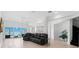 Open-concept living room with waterfront view, and access to the outdoor patio at 6130 Kipps Colony W Dr, Gulfport, FL 33707