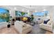 Bright and open living room with large windows showcasing the beautiful waterfront view at 6130 Kipps Colony W Dr, Gulfport, FL 33707