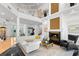 Elegant living room with high ceilings, fireplace, and views, designed for entertaining and relaxing at 6130 Kipps Colony W Dr, Gulfport, FL 33707