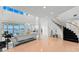 Open-concept living room with staircase, water views, and hardwood floors at 6130 Kipps Colony W Dr, Gulfport, FL 33707