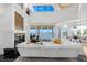 Bright living room with a fireplace, expansive windows, and luxurious furnishings, creating an inviting space at 6130 Kipps Colony W Dr, Gulfport, FL 33707